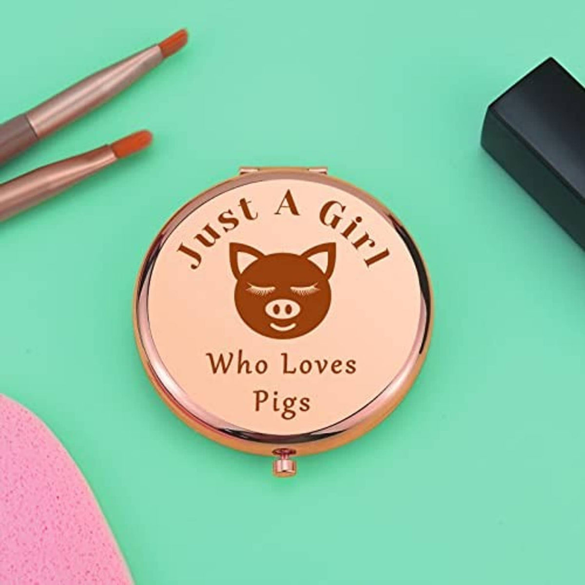 Rose-gold pig-themed compact makeup mirror with flip-top closure
