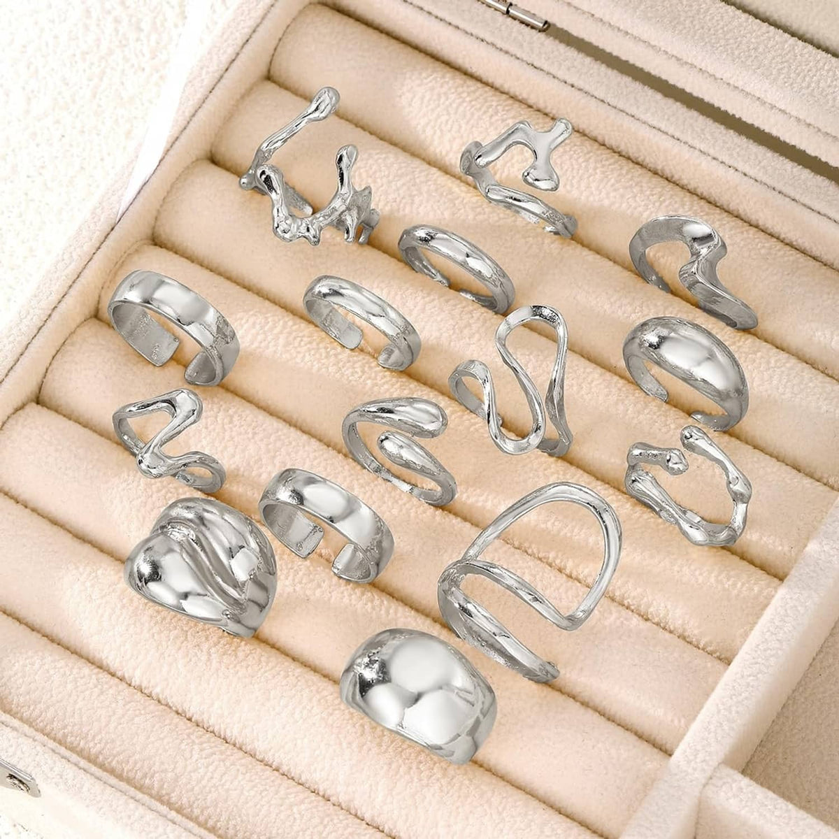 Silver ring set neatly arranged in jewelry box, mix of chunky bands and openwork styles