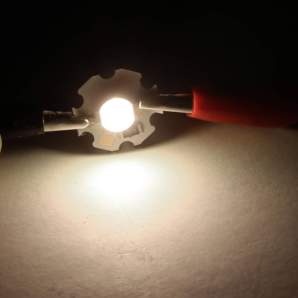 Warm white LED chip shining bright light beam from metal base