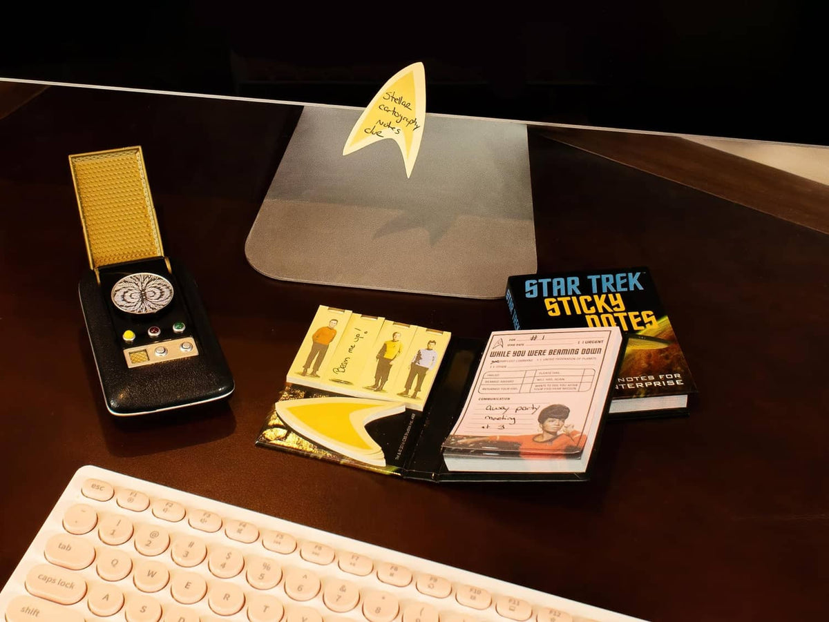 Sticky notes set on desk with small device stand, inserts, and note pads