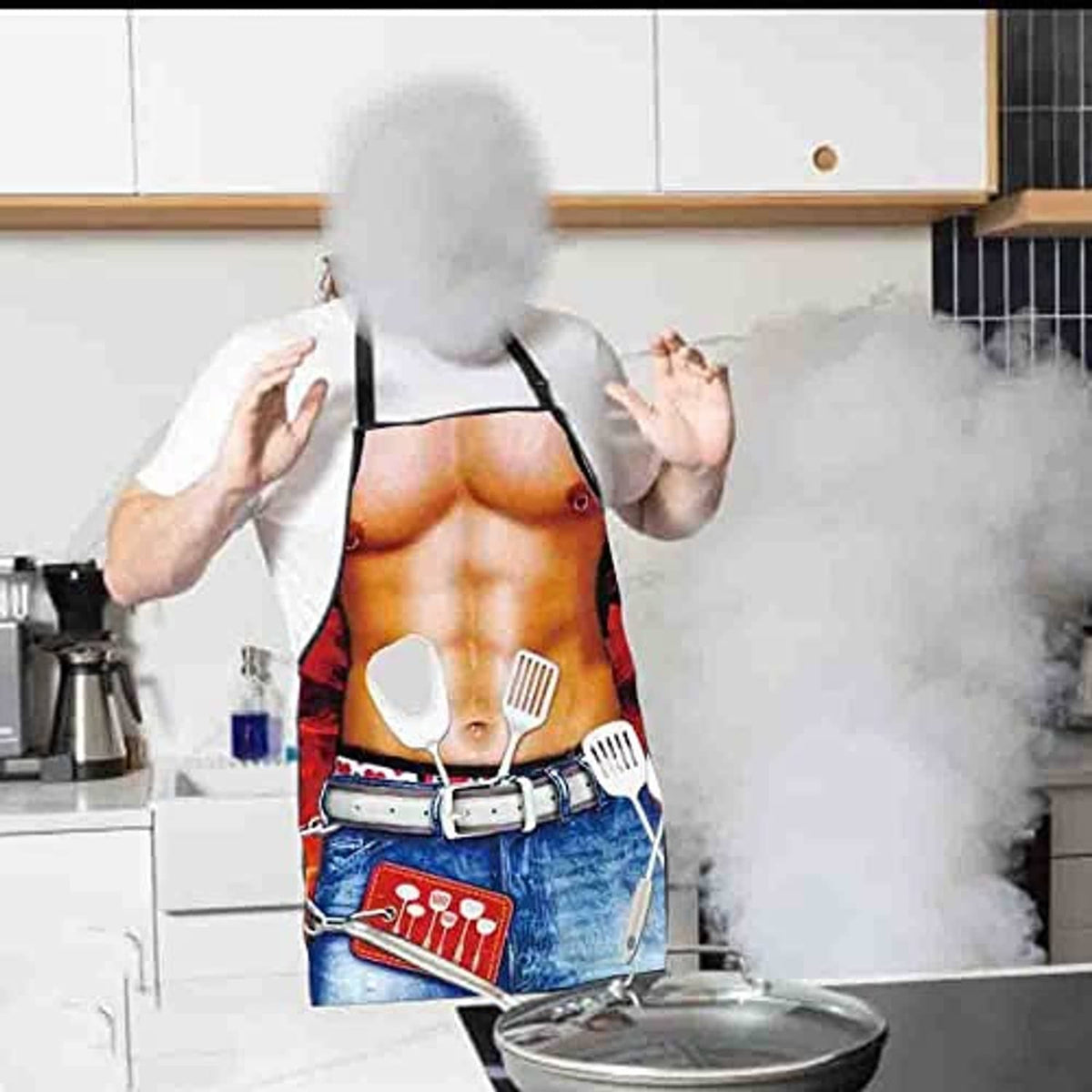 Chef wearing novelty bib apron with kitchen utensils print and blue denim-style pocket