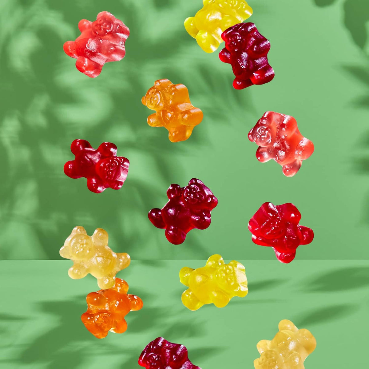 Assorted organic gummy bear candies in red, orange, yellow, pink, and green.