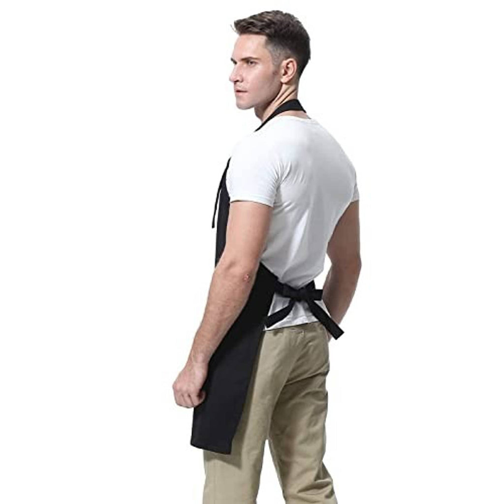 Black apron with adjustable neck strap and cross-tied back, worn over a shirt.