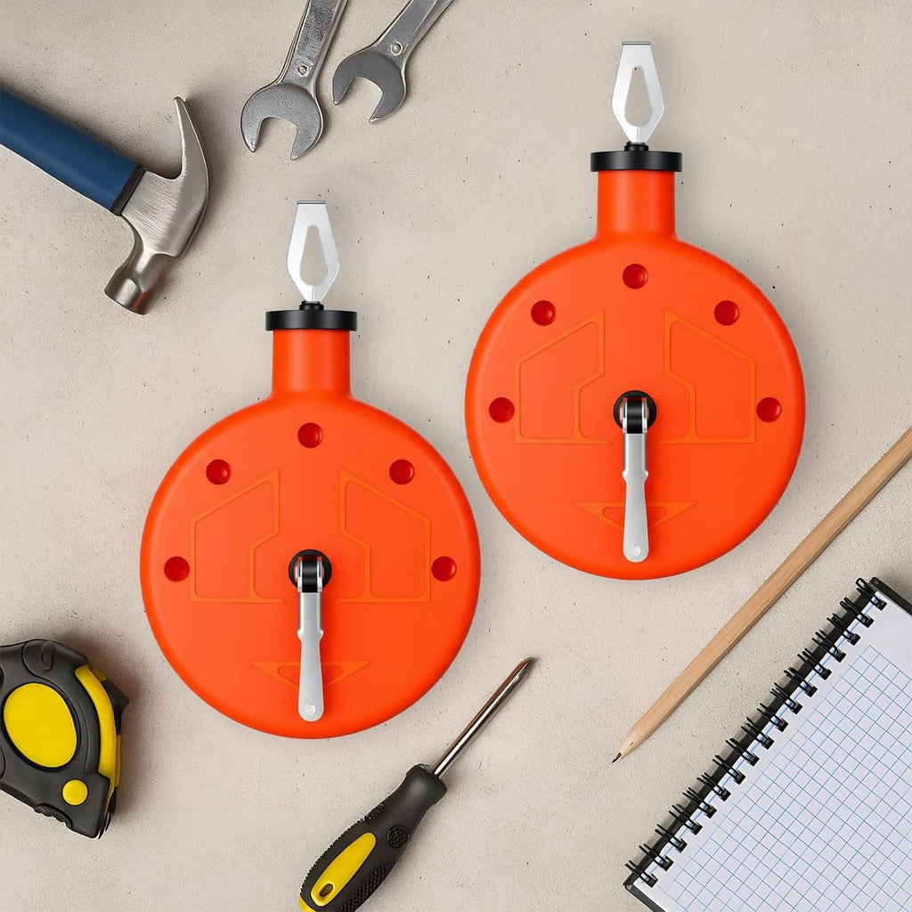 Two orange chalk line reel tools laid out with metal crank handles