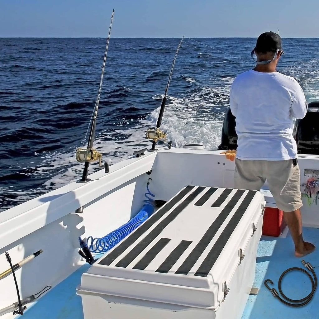 Rod strap holder mounted on a boat deck with black strap and metal hook end