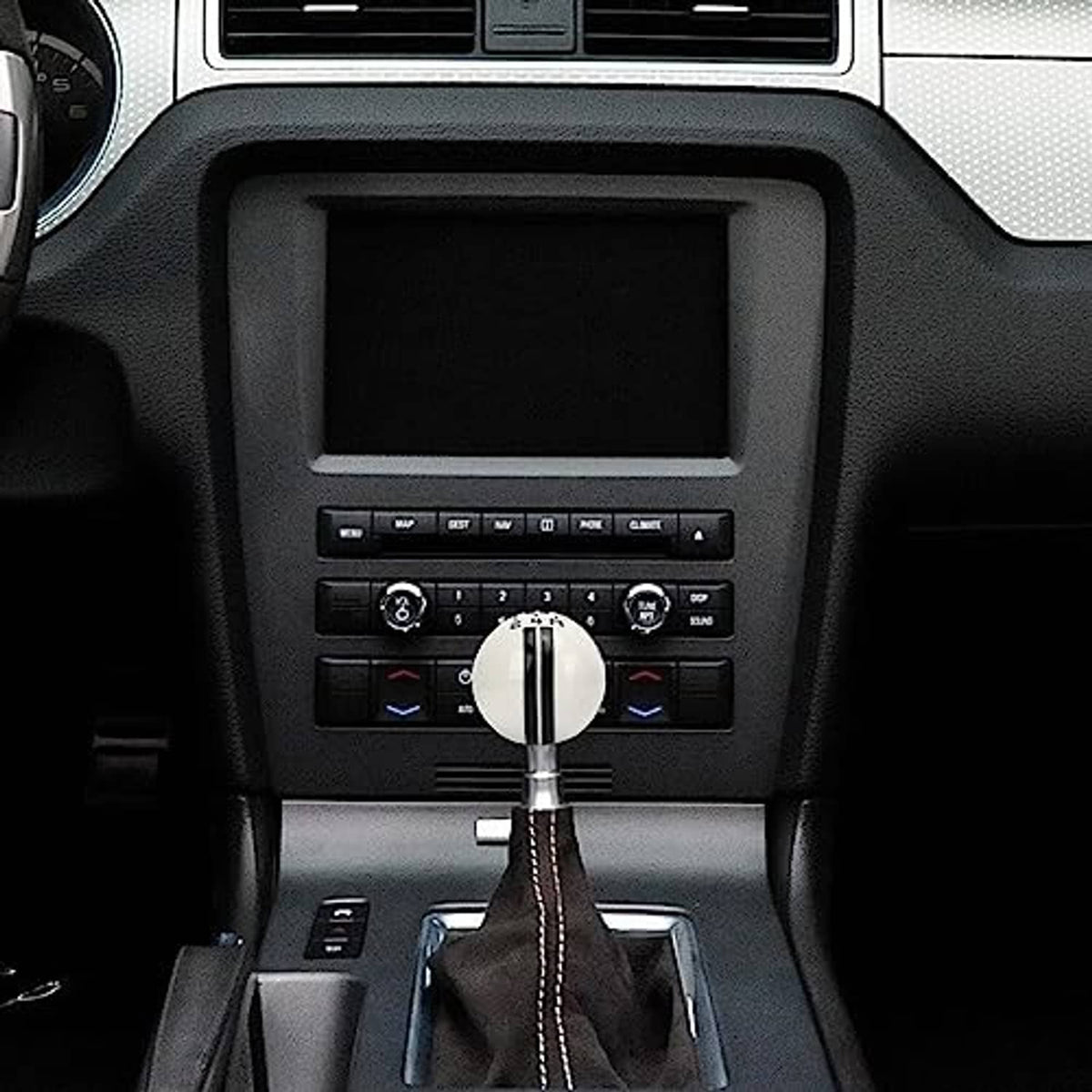 White shift knob with chrome trim and leather boot in center console