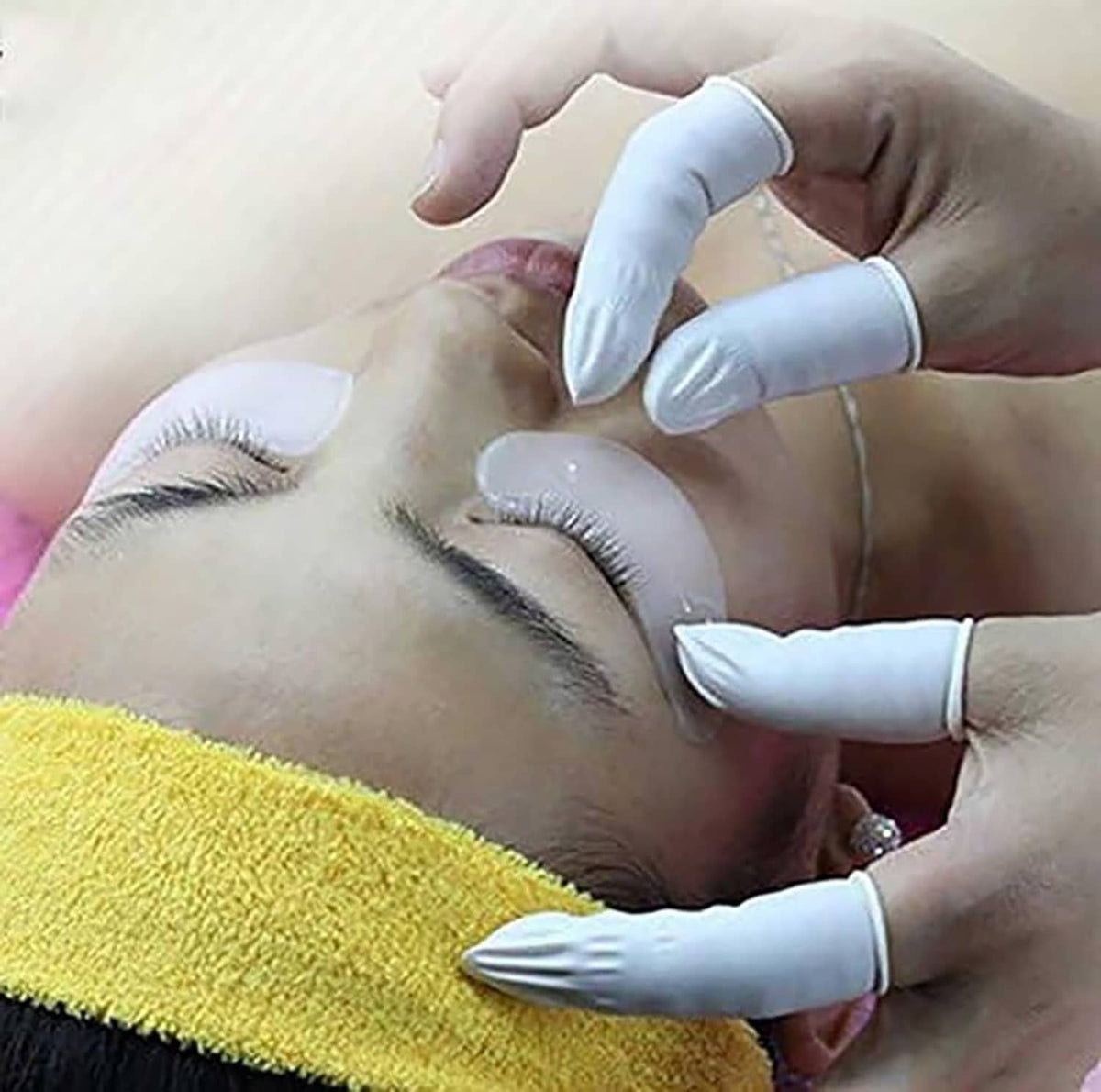White latex finger cots on hands during use for hygiene and protection