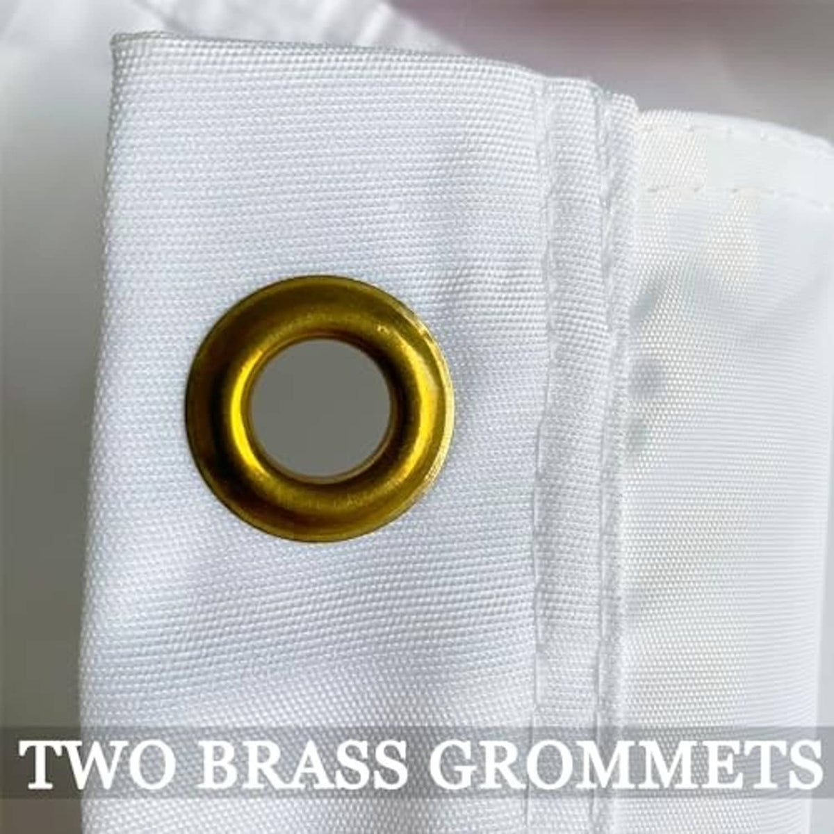 Embroidered US Army flag corner with two brass grommets on white fabric