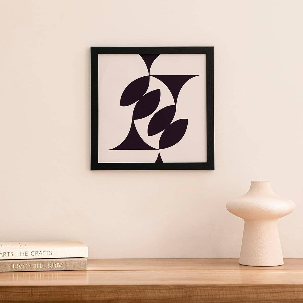 Black 12x12 picture frame with bold dark abstract leaf artwork print.