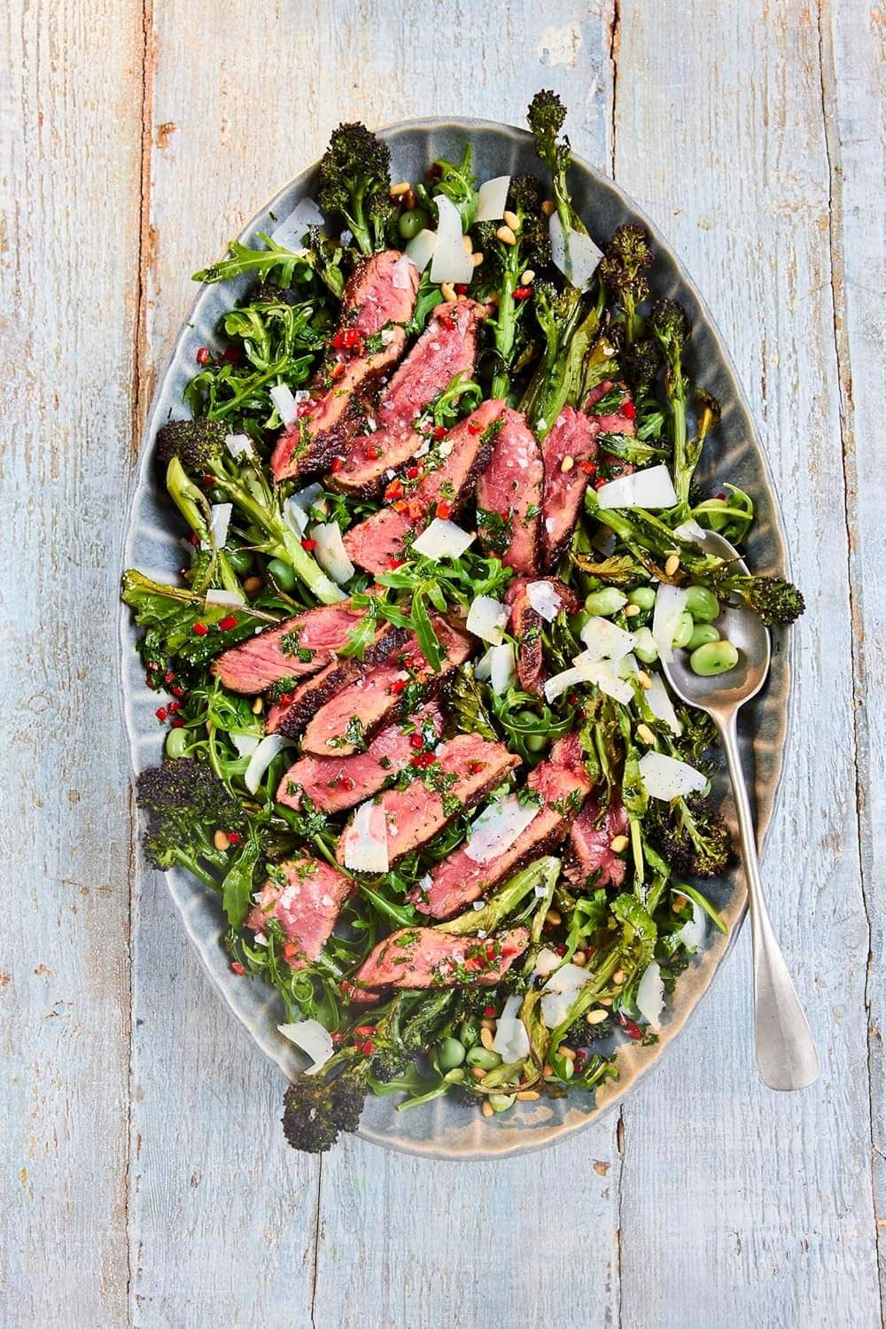 Smoked sea salt flakes sprinkled over greens and sliced meat