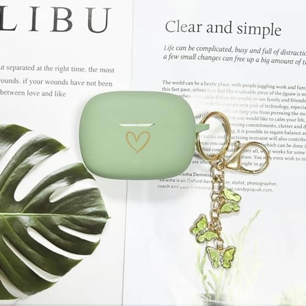 Matcha green silicone earbud case cover with heart emblem and butterfly keychain