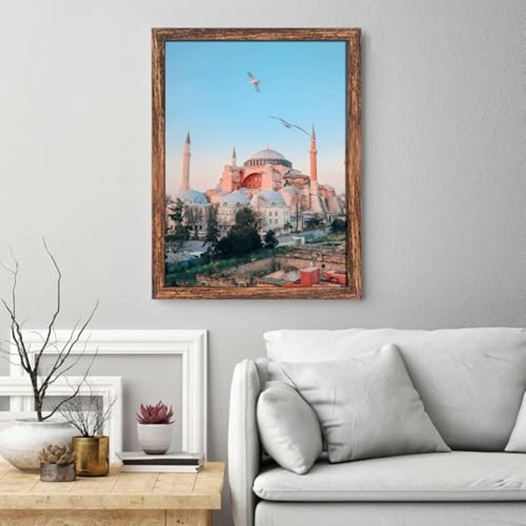 Brown wall poster frame with a landscape print and clear glass front