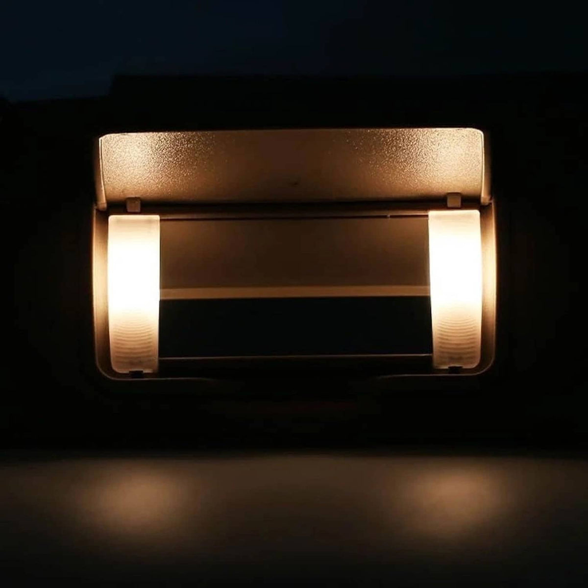 Close-up of tan sun visor LED mirror light panels turned on