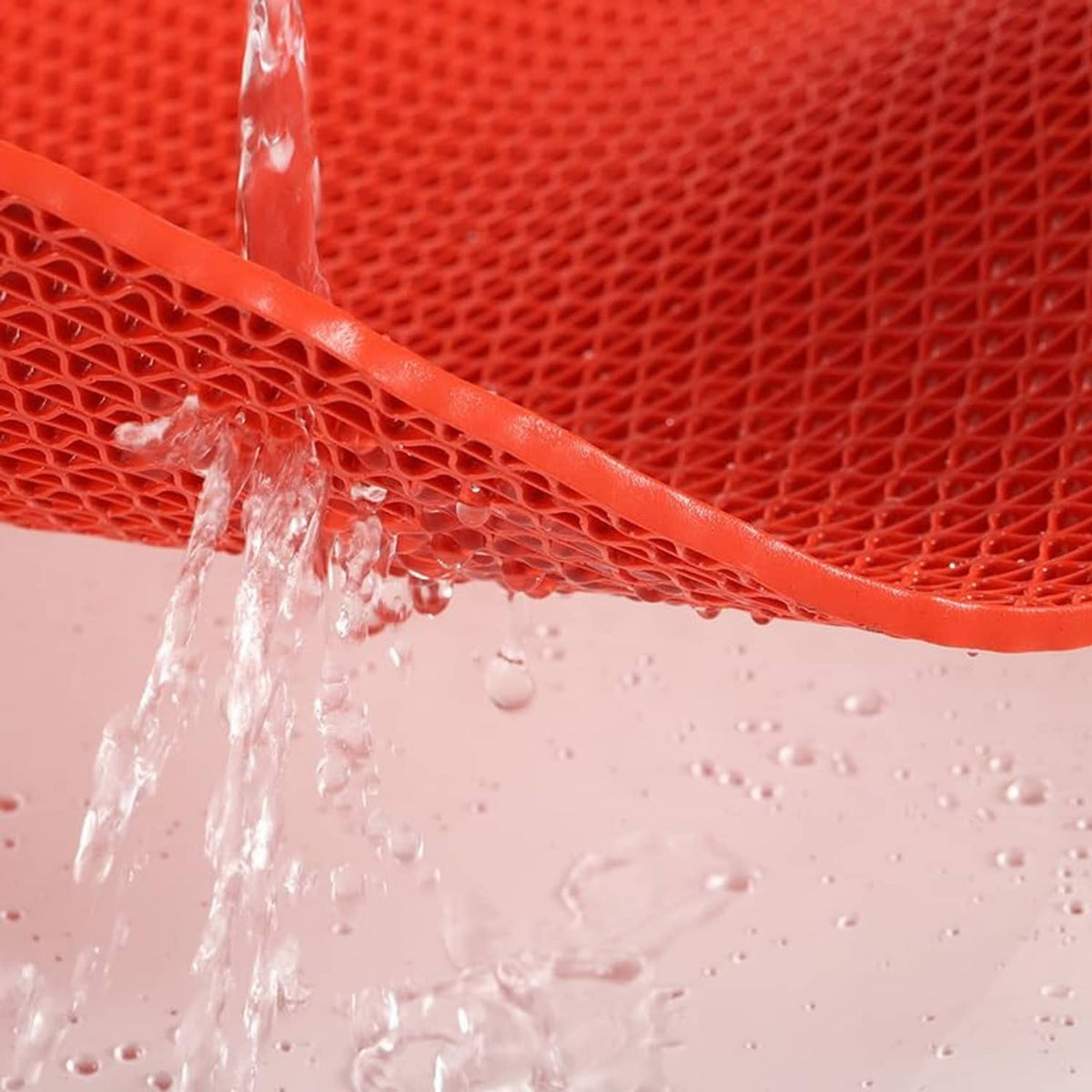 Red non-slip PVC mat with raised lattice texture and water droplets