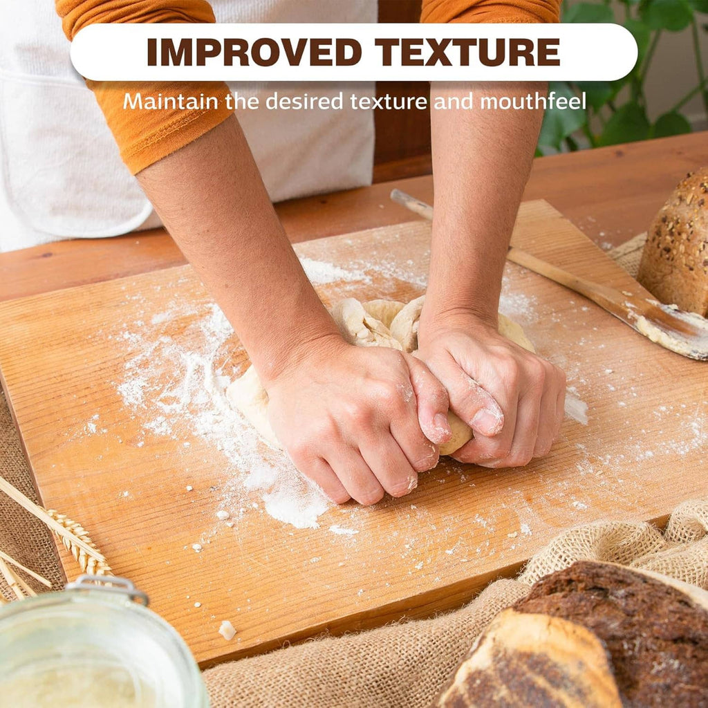 Potassium bicarbonate powder sprinkled on dough with hands on a wooden board