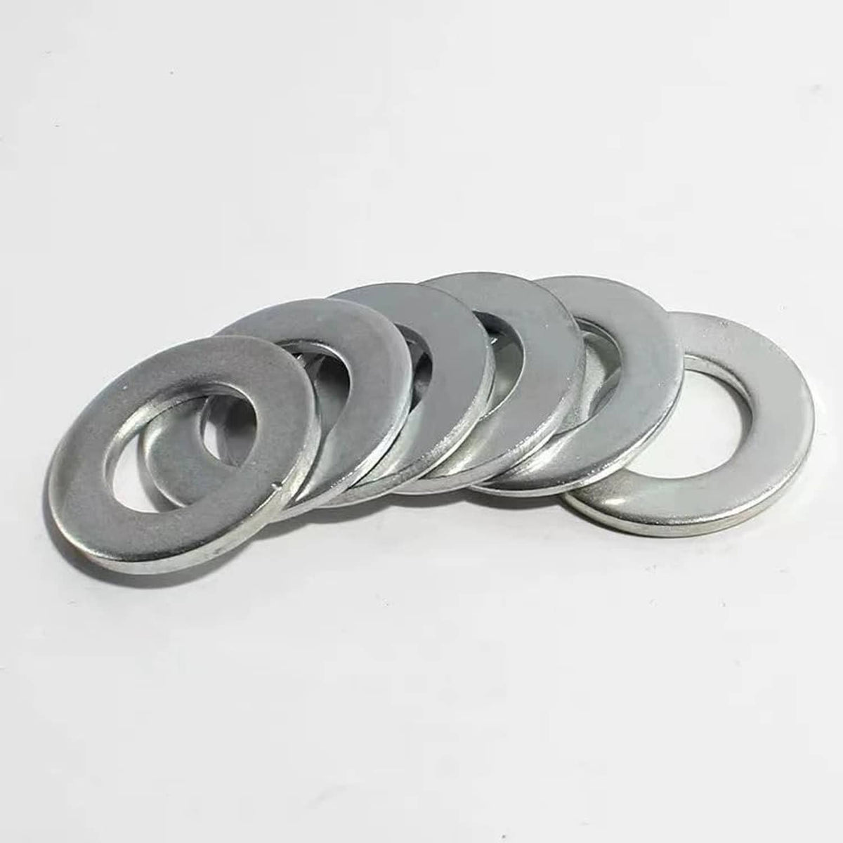 Stack of silver crush washers, round metal rings with center holes