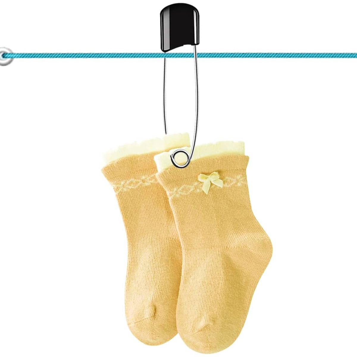 Black plastic-head safety pin holding a pair of yellow baby socks