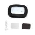 Black dome car reading light with glowing LED panel and USB cable and adhesive pads