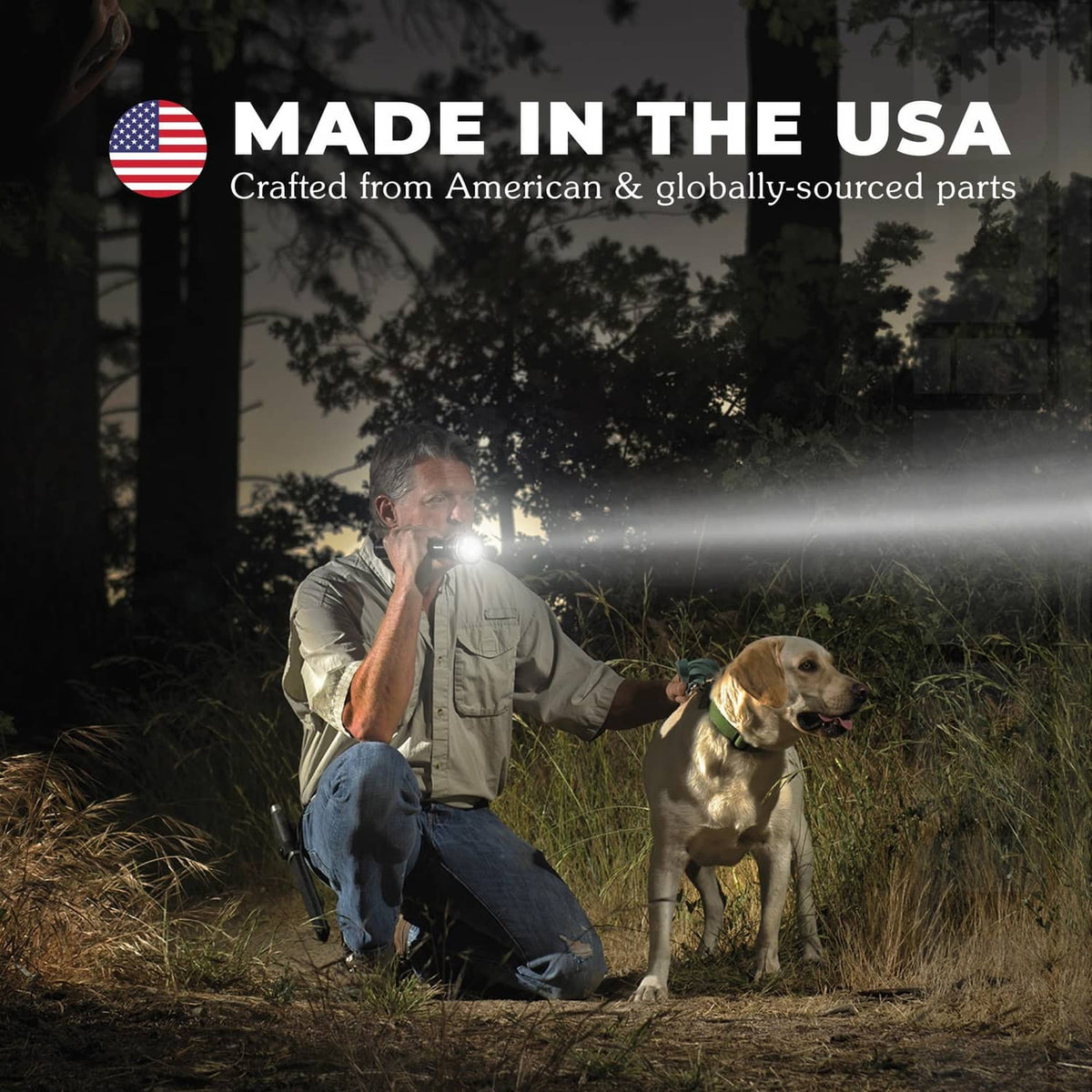 Silver flashlight shining a bright beam outdoors while held by a person