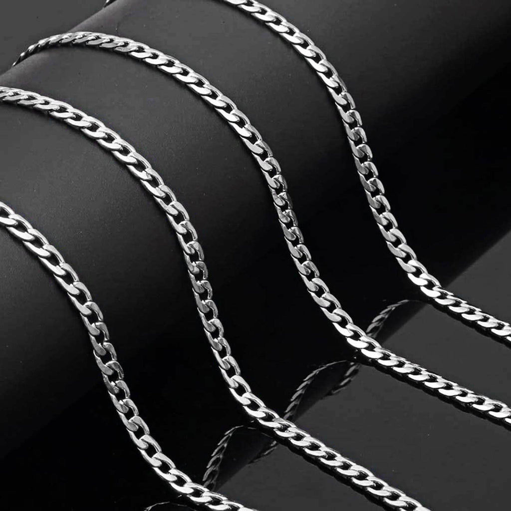 Silver Cuban link chain draped in curved rows with polished oval links