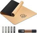 Large cork yoga mat with tan surface and black non-slip underside, rolled and flat