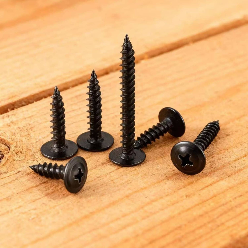 Black Phillips-drive truss-head self-tapping screws on light wood plank