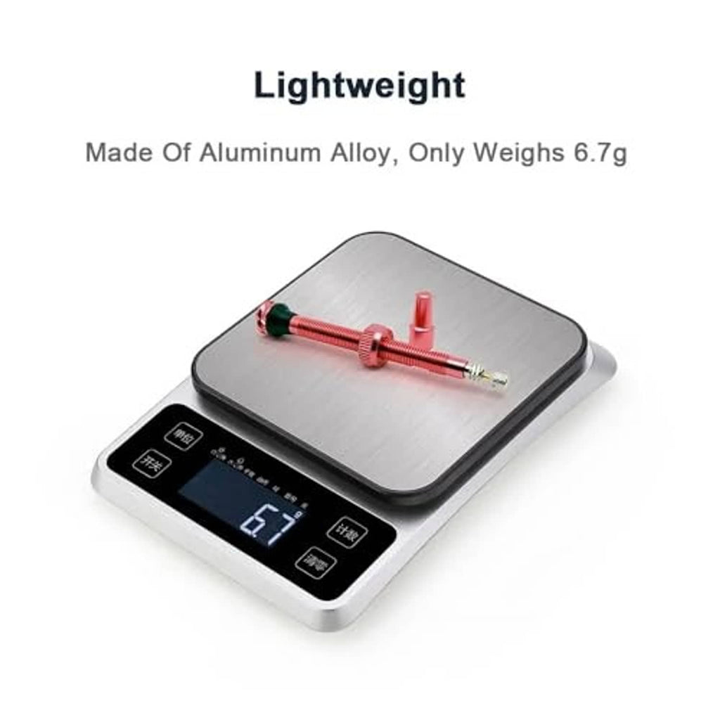 Red Presta valve stem set weighed on a digital scale