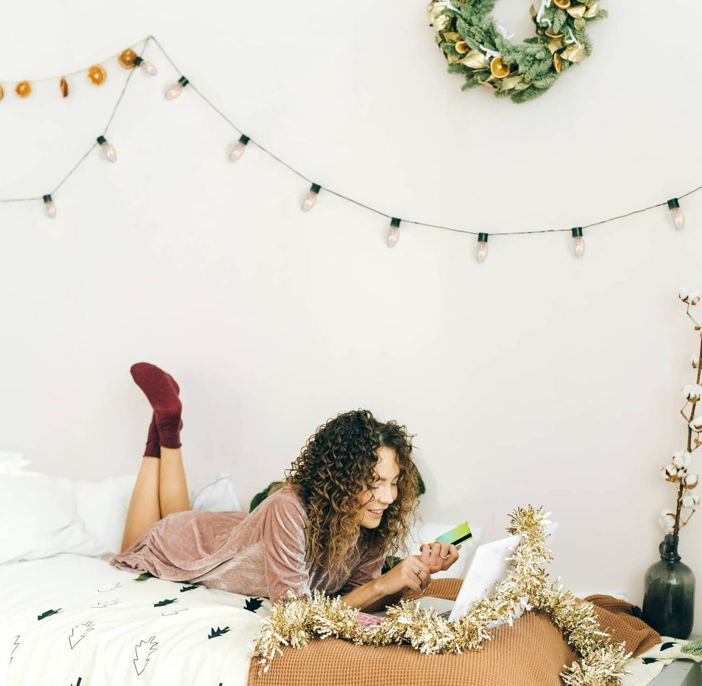 Warm string lights over a bed