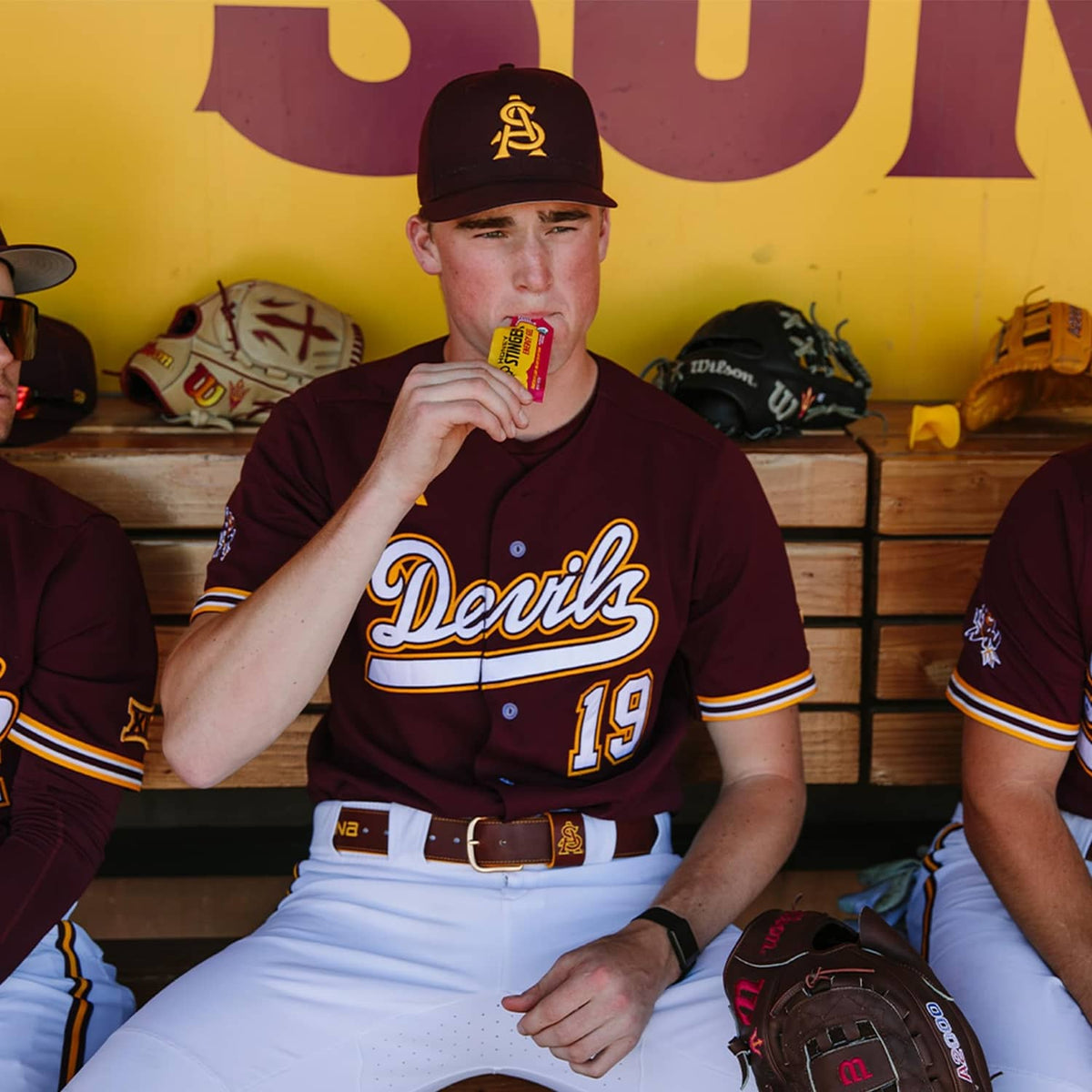 Athlete holding a Honey Stinger energy gel packet to eat