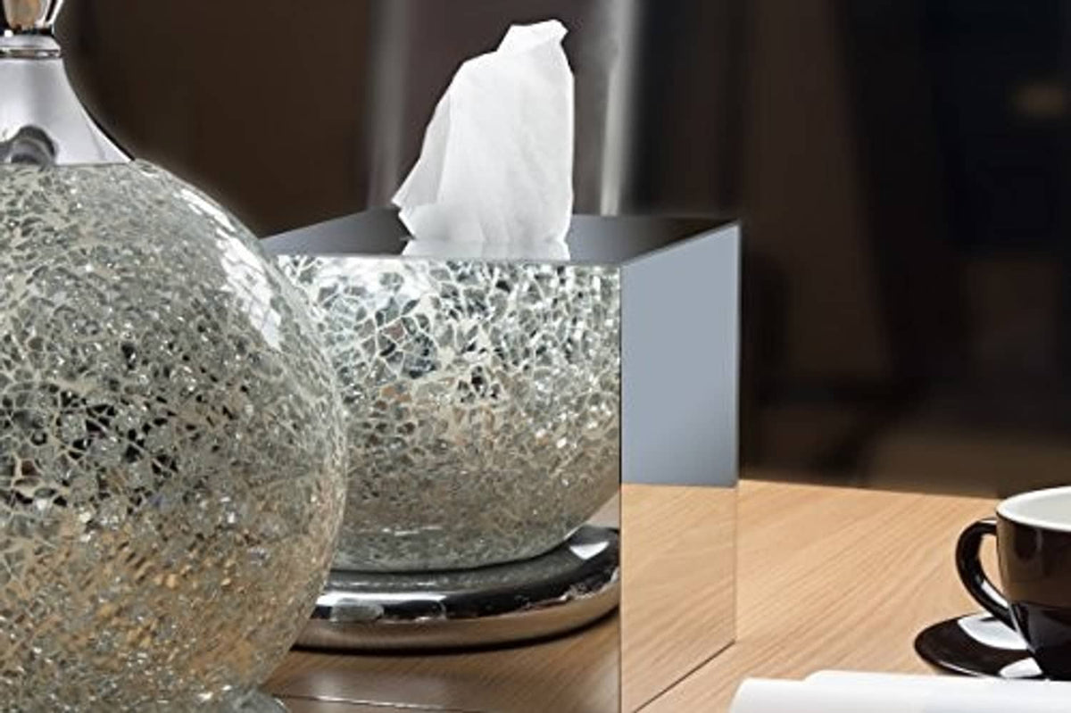 Square acrylic mirror tissue box cover on a table with tissue visible above the top