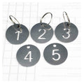 Stainless steel number key tags with rings, showing tags 1–5