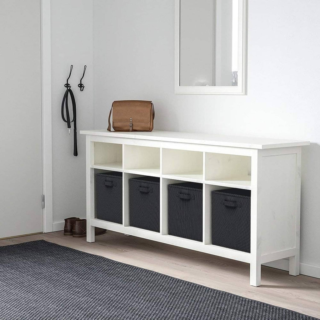 Black foldable fabric storage cubes with pull handles in a white bench shelf