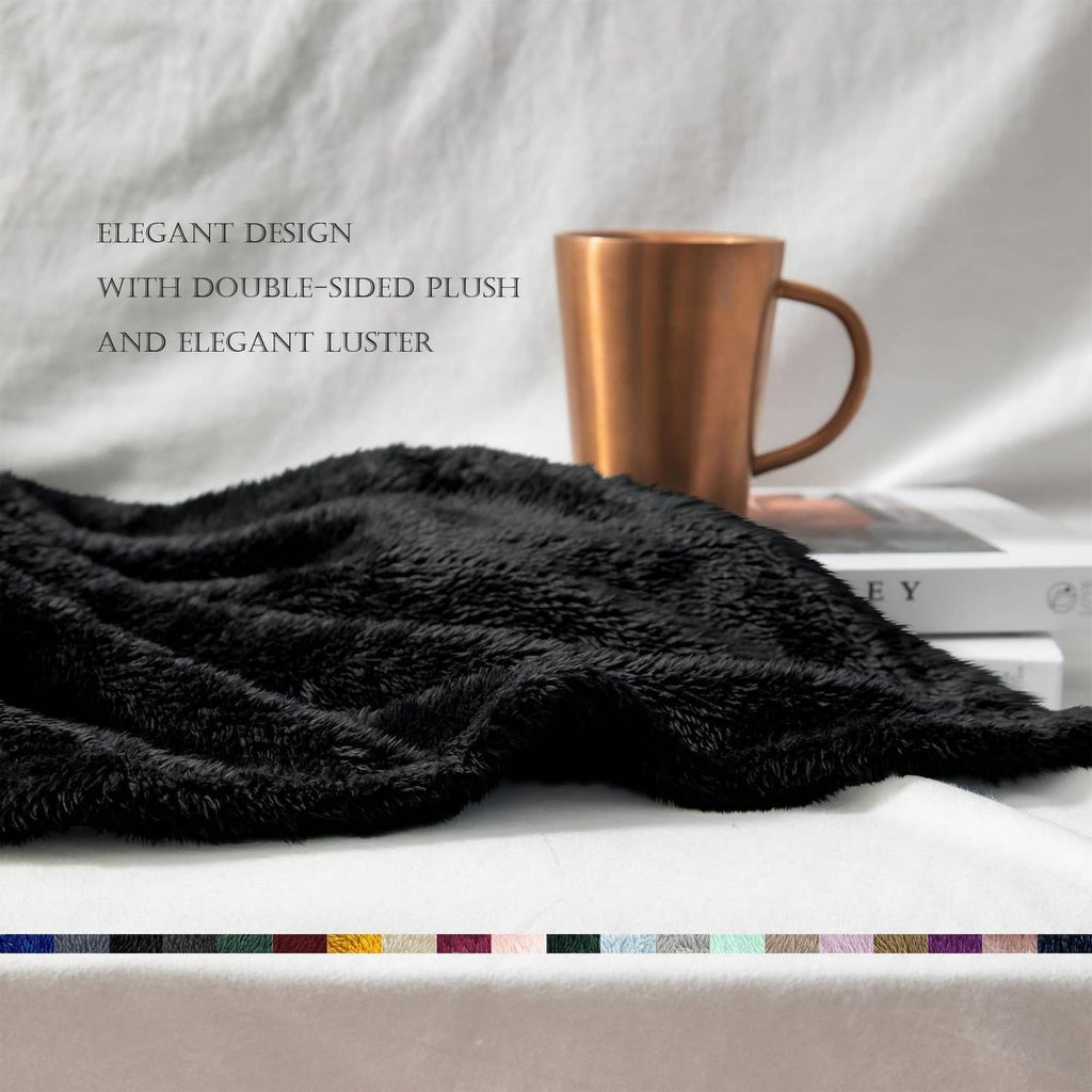 Black plush fuzzy throw blanket with dense shag texture, lying flat on bed