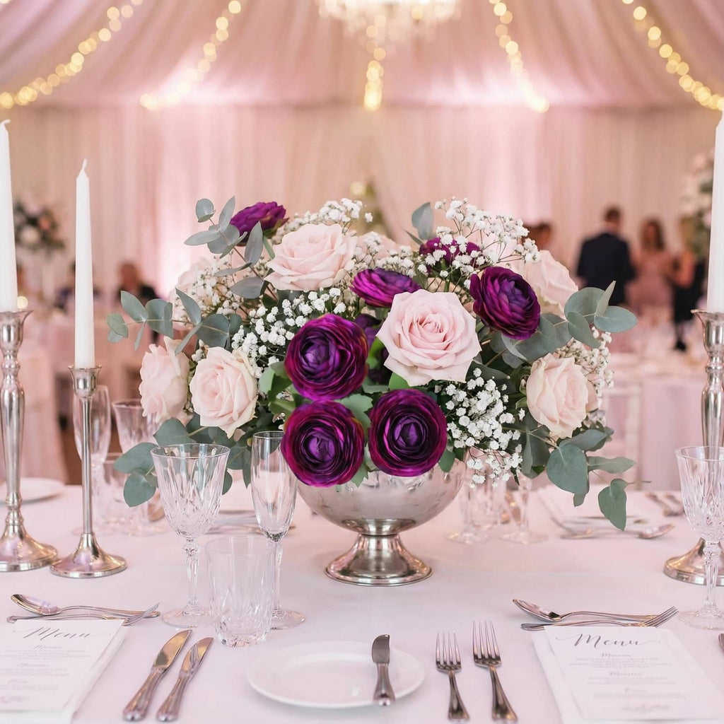 Purple ranunculus centerpiece with pink and white flowers and green eucalyptus leaves