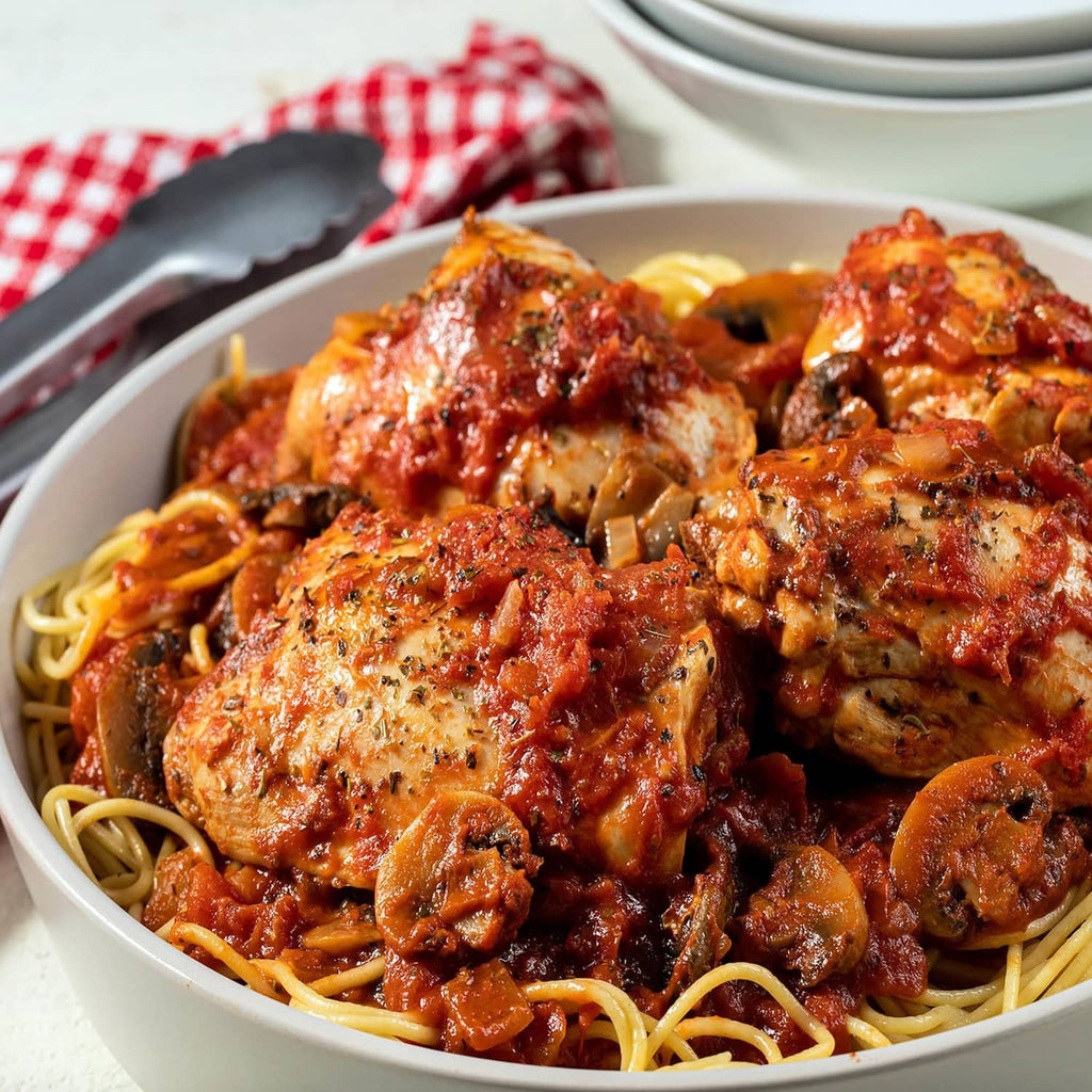 Plate of spaghetti with Italian mushroom-style sauce, mushrooms, and meatballs