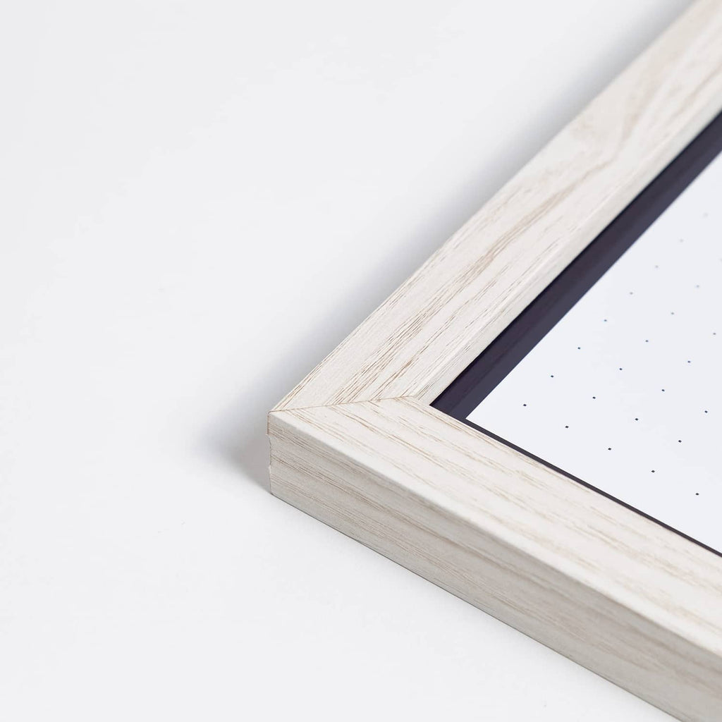 White wooden frame corner of 14 x 14 weekly dry erase board