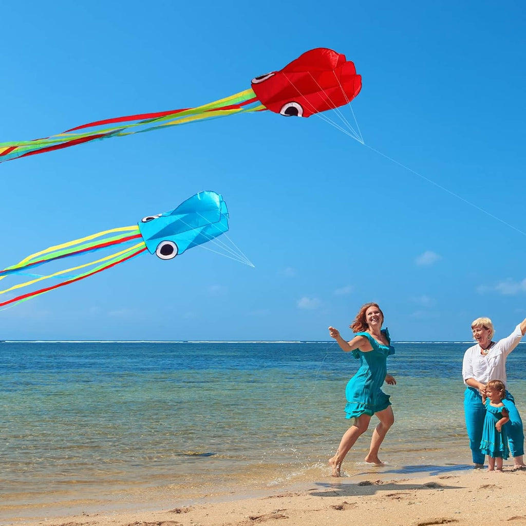 Red and blue octopus kites flying above the shoreline
