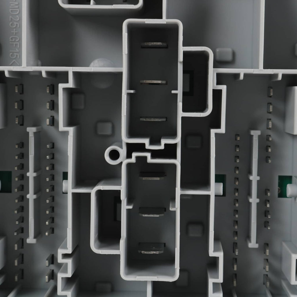 Close-up of gray power distribution center with multi-pin connector blocks