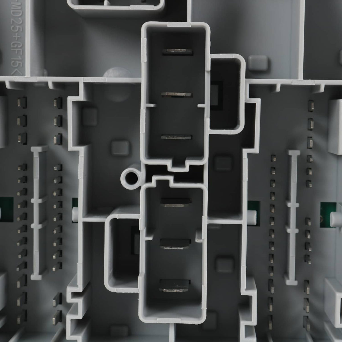 Close-up of gray power distribution center with multi-pin connector blocks