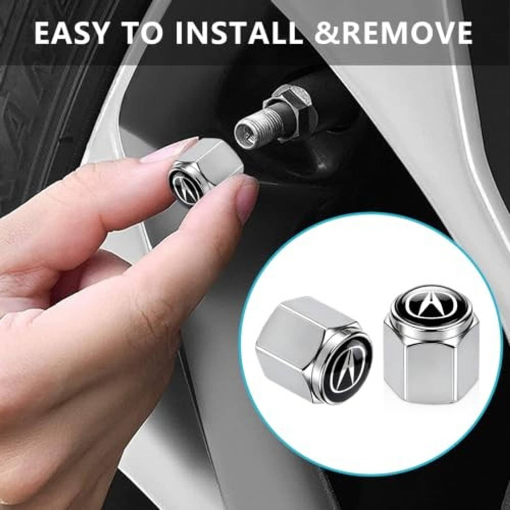 Silver tire valve stem cap with black top and white emblem being installed by hand
