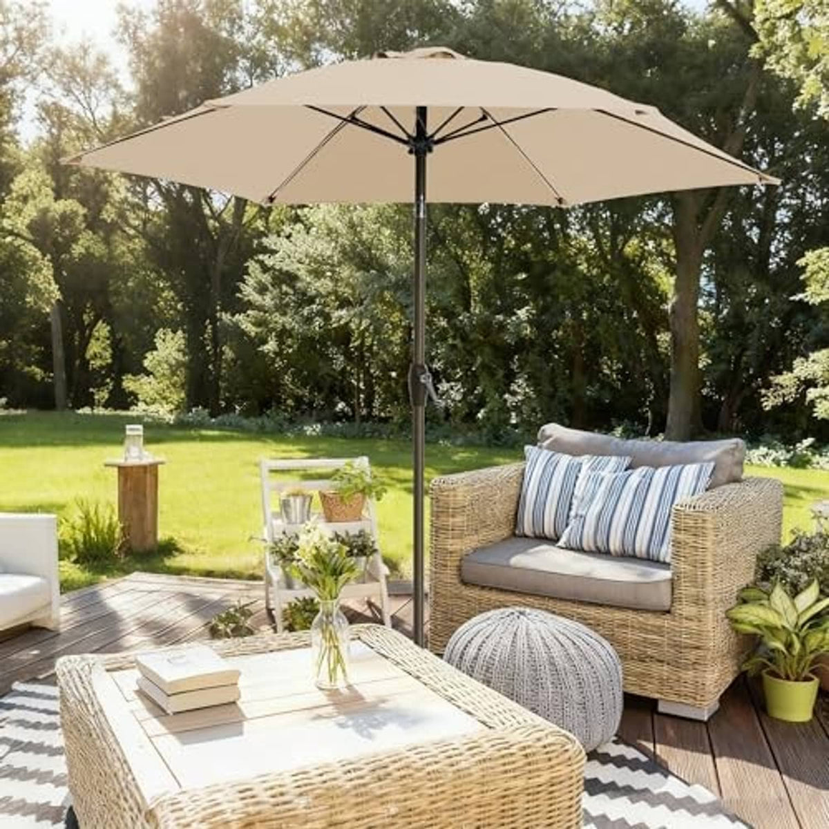 Beige outdoor patio umbrella open above wicker seating and glass patio table