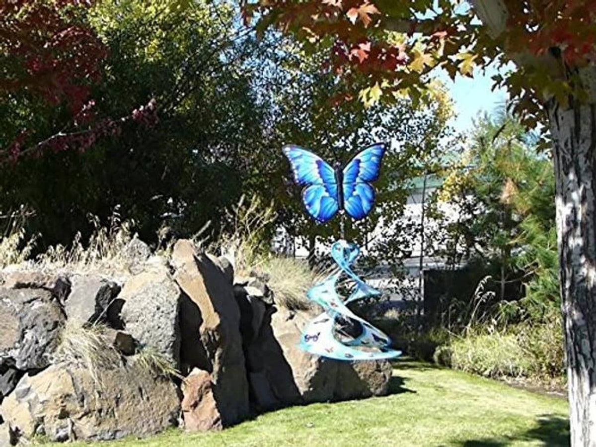 Blue butterfly wind spinner with spiral and disc charms, suspended on cord