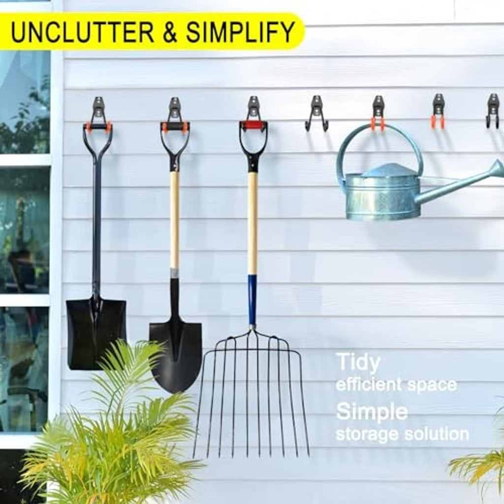Black wall hooks holding garden tools and watering can for tidy storage