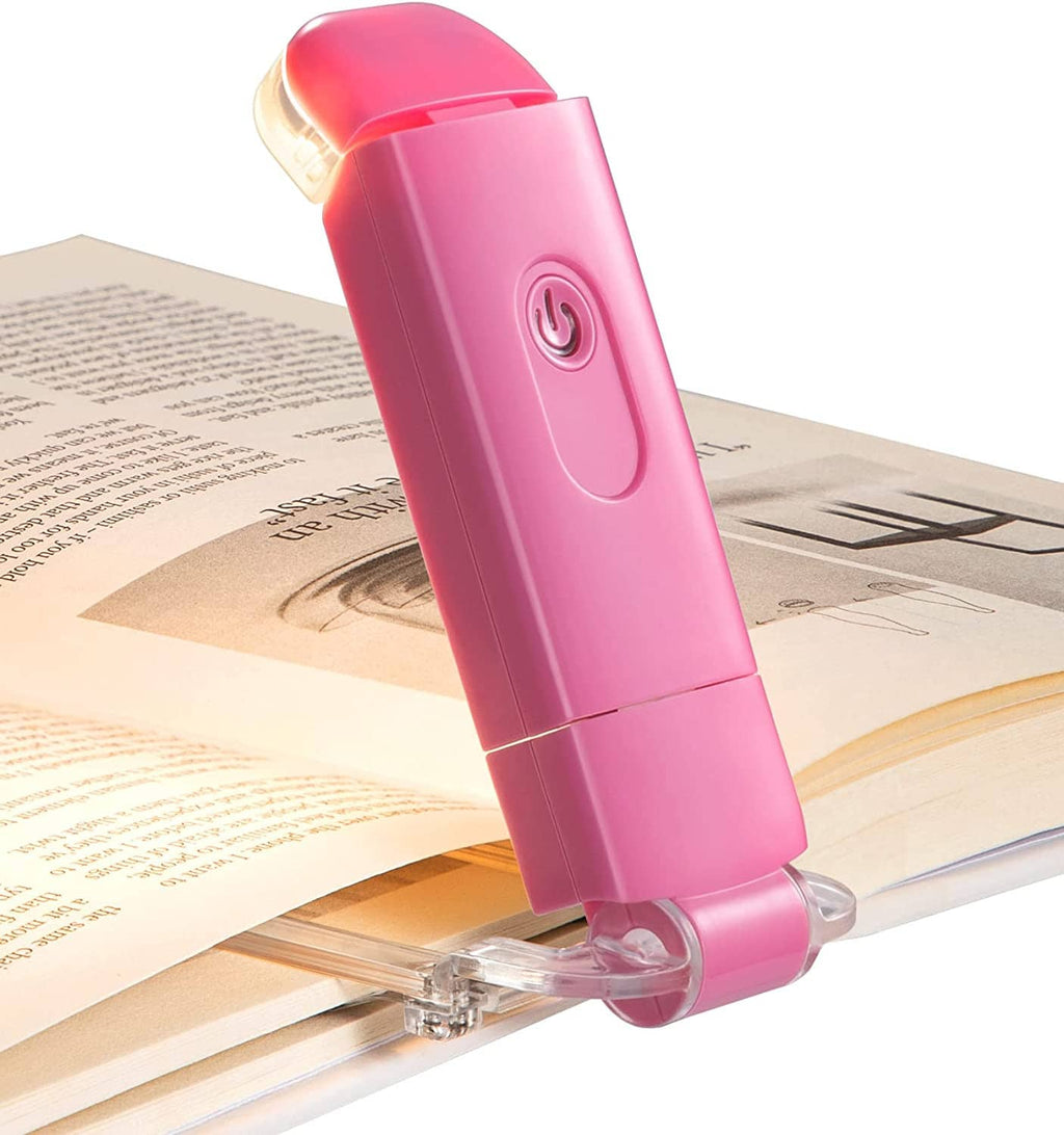Pink clip-on LED book reading light with clear clamp and illuminated head