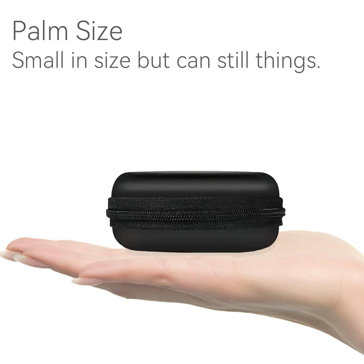 Compact black round earphone case resting in an open palm, smooth hard shell