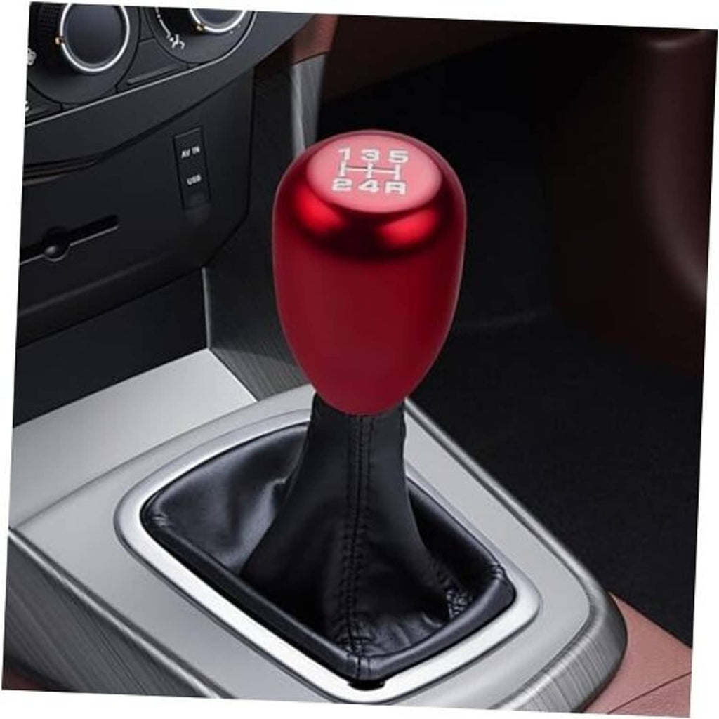 Red 5-speed gear shift knob on black leather boot with silver shifter trim