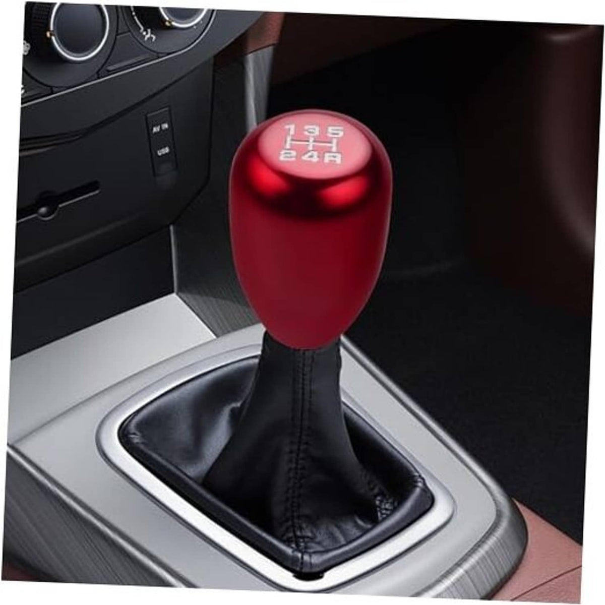Red 5-speed gear shift knob on black leather boot with silver shifter trim