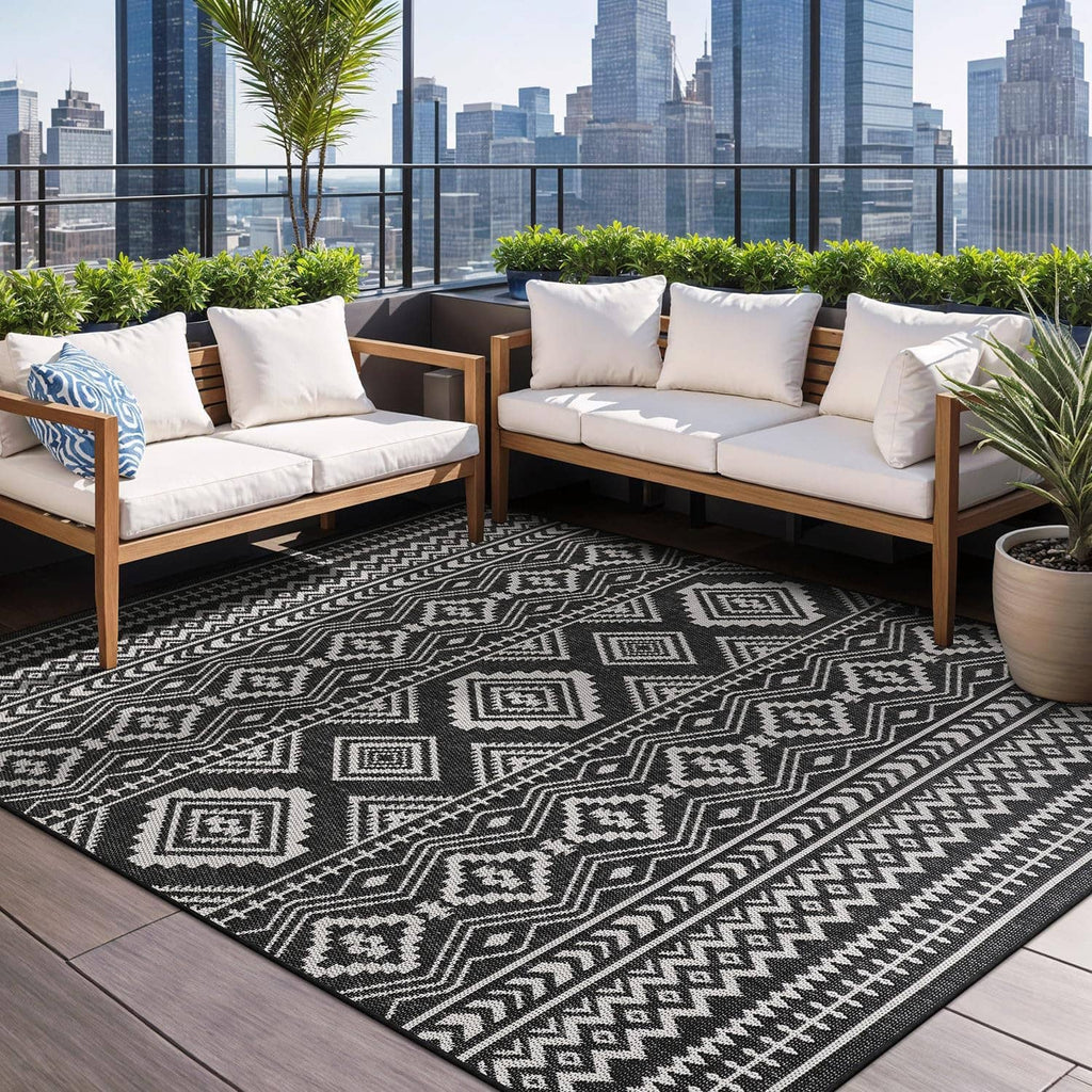 Geometric black-and-white rug with diamond, zigzag, and striped bands