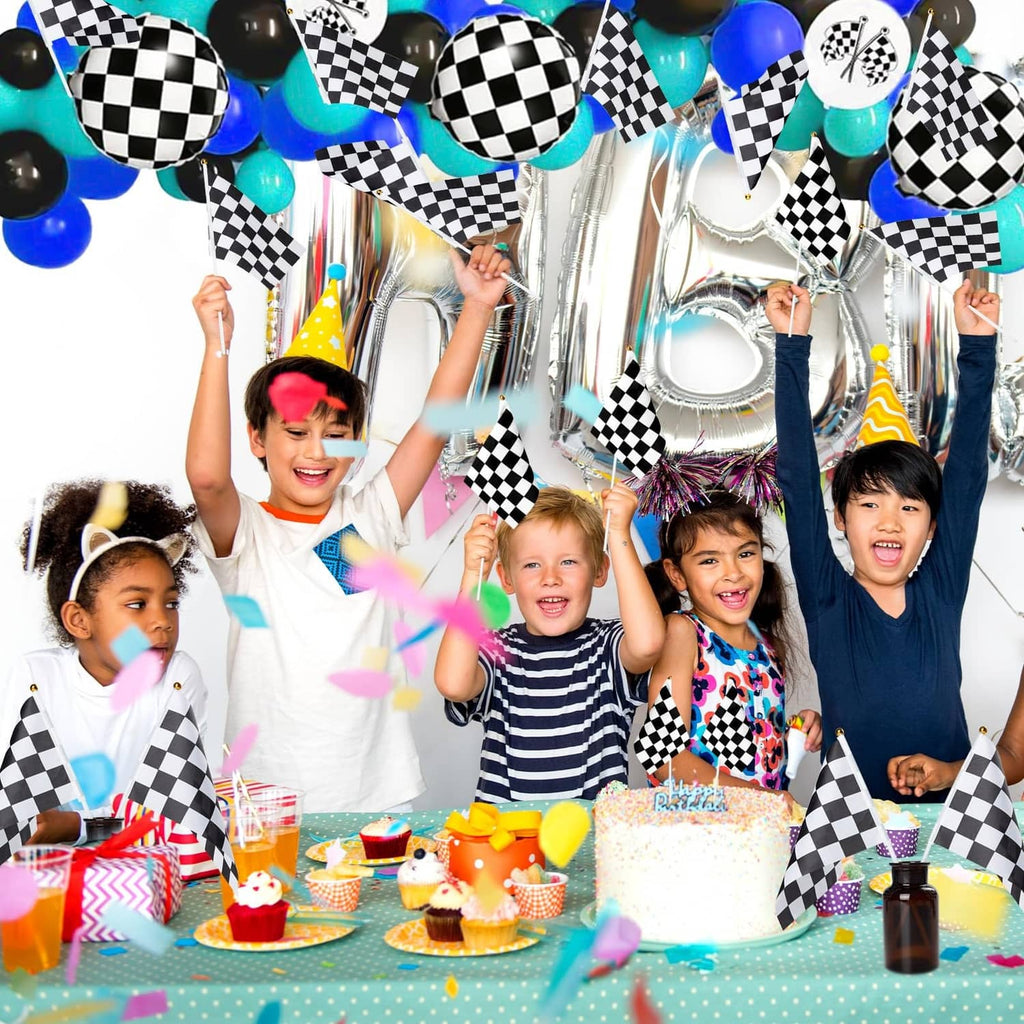 Black-and-white checkered race flags on sticks at a birthday party scene