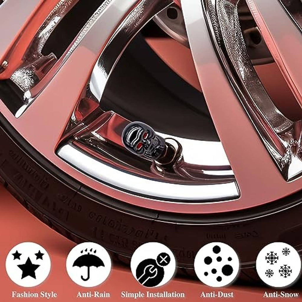 Skull tire valve stem cap, glossy black with red eyes, installed on wheel valve